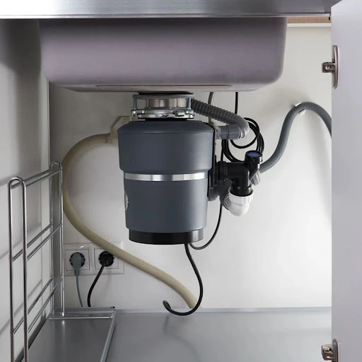 plumber installing new garbage disposal Denver